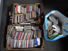 Two boxes and a bag of various DVDs