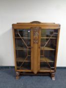 An Edwardian carved oak double door bookcase on carved bulbous legs