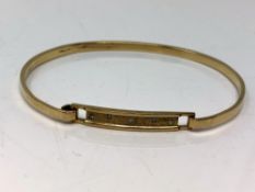 A 9ct gold diamond set bangle