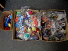 Two boxes and a bag containing a very large quantity of McDonald's Happy Meal toys ,