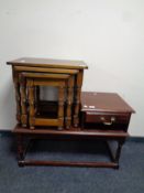 A nest of three tables together with a telephone table in an oak finish
