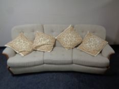 A mid 20th century Ercol wood frame lounge suite in beige fabric