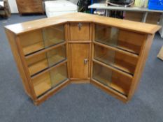 A set of mid 20th century corner bookshelves with sliding glass doors,
