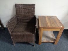 A rattan armchair and an occasional table in walnut finish