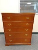 A Stag five drawer chest in a teak finish