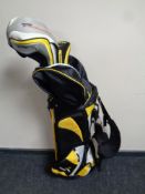 A Cobra golf bag containing umbrella and three drivers,