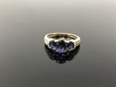 A 9ct gold dress ring set with diamond shoulders