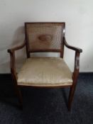 A 20th century beech bergere backed armchair