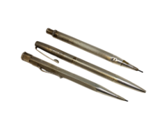 Three silver propelling pencils.