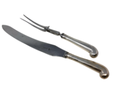 A silver-handled carving knife and fork, London marks rubbed, length 35cm.