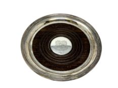 A Georgian silver and turned wooden bottle coaster, engraved with a crest, diameter 14cm.