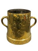 A seventeenth century brass twin handled vessel,
