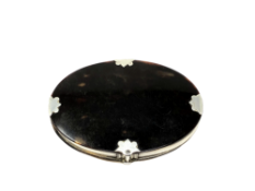 A 19th century tortoiseshell and white metal mounted magnifying glass, width 8.5cm.