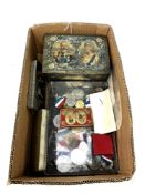 A collection of tins and medals relating to Royal Coronations,
