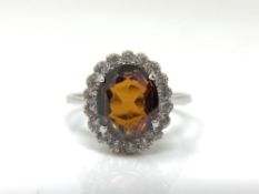 An 18ct white gold garnet dress ring, size P.