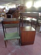 A storage cupboard in a mahogany finish together with two bedside tables fitted a drawer in a