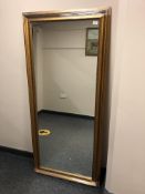 A contemporary rectangular golden framed mirror,