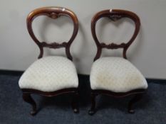 A pair of Victorian mahogany balloon back chairs