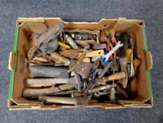 A box containing vintage hand tools and a blow lamp