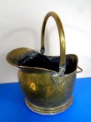An antique brass swing handled coal bucket