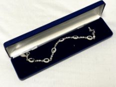 A decorative white metal stone set bracelet