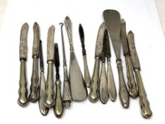 A collection of silver handled cutlery, button hooks,