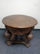 A continental oak circular coffee table on bulbous legs