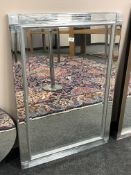 A bevelled mirror with square corners,