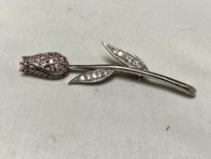 A silver stone set brooch modelled as a flower