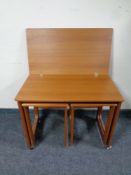 A 20th century teak turnover top table on castors with two tables beneath
