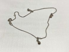 A silver ankle bracelet