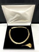 A flat link gold plated necklace with matching leaf brooch