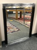 A contemporary black framed mirror,