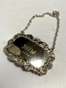 A silver rum decanter label