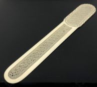 A fine late 19th century ivory page turner with exquisite intricate carving, length 31 cm.