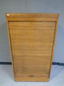 An Edwardian oak shutter front cabinet with key, width 78 cm,