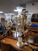 A decorative brass and glass four way table lamp with glass fluted shades