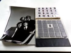 A folder of 35mm negatives relating to The Beatles and a rolled black and white Beatles poster