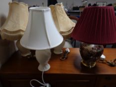 An oriental style table lamp with shade depicting geishas together with three further ceramic table