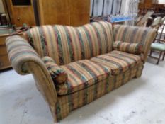 A contemporary drop end sofa upholstered in a classical striped fabric