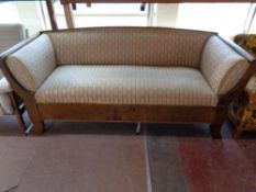 A late 19th century mahogany framed settee upholstered in a classical striped fabric