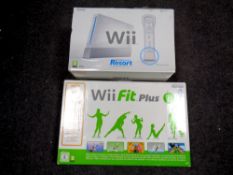 A Nintendo Wii console with accessories together with a Wii Fit,
