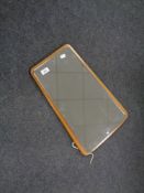 A 1970s mirror mounted on a teak board