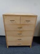 A continental blonde oak six drawer chest