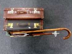 A box containing a vintage luggage case together with a further vintage style luggage case,