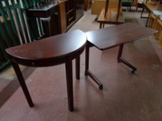 A stained pine bed table on casters together with a D shaped hall table fitted two drawers,
