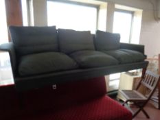 A mid 20th century Scandinavian three seater settee upholstered in a dark green fabric