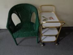A wicker basket chair together with a gilt three tier tea trolley