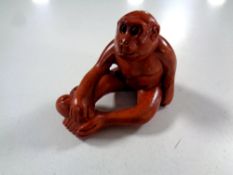 A carved Chinese hardwood netsuke,