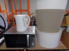 A Kenwood microwave together with a kettle and four standard lamp shades